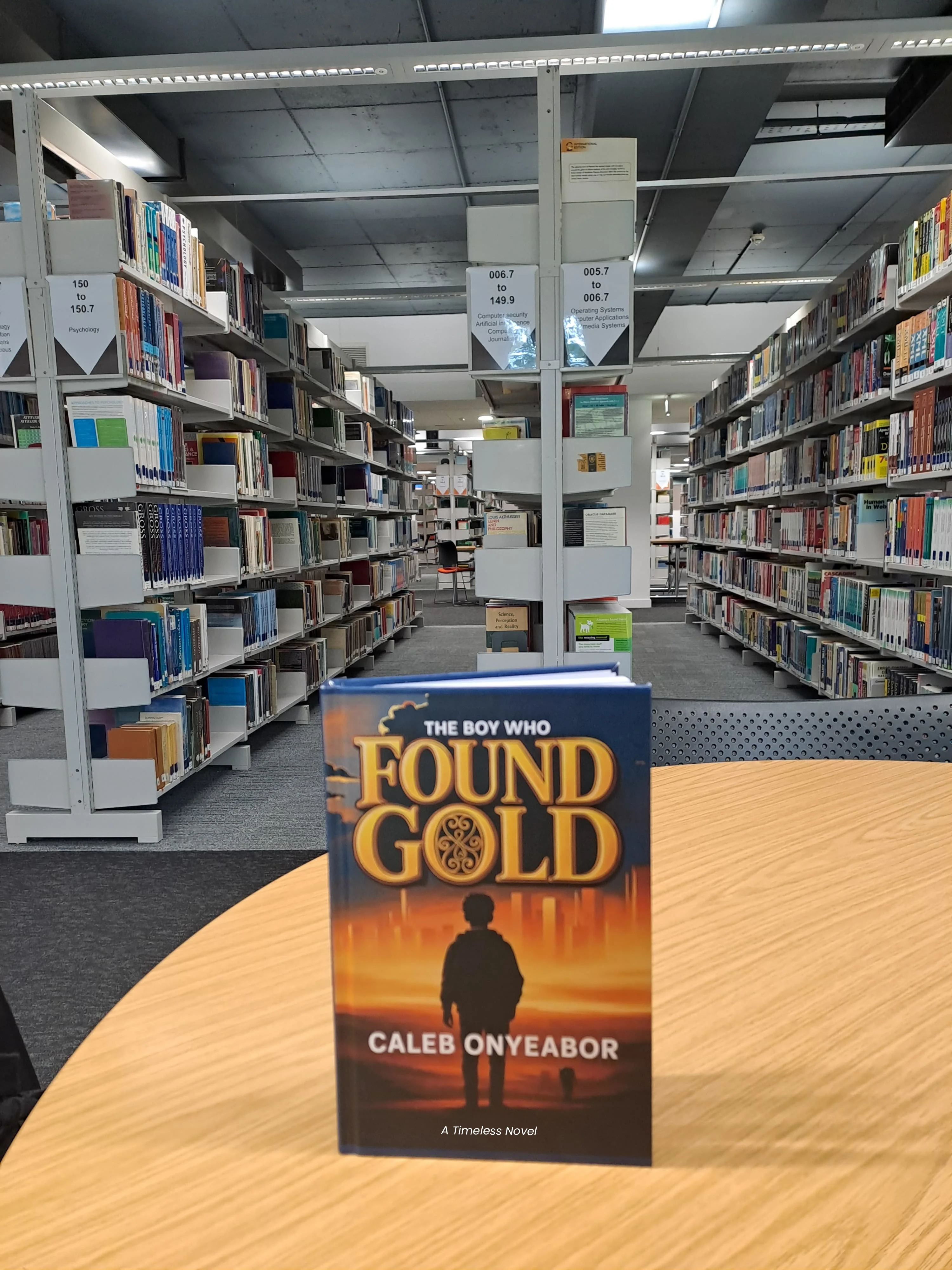 Students reading The Boy Who Found Gold novel at Aston University Library, United Kingdom - timeless inspirational book by Caleb Onyeabor