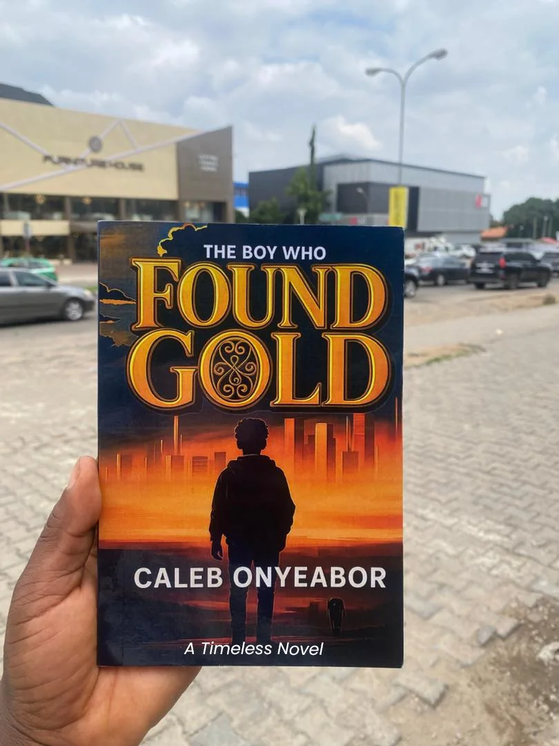 Reader holding The Boy Who Found Gold novel by Caleb Onyeabor in Lagos, Nigeria - transformative fiction about dreams and perseverance