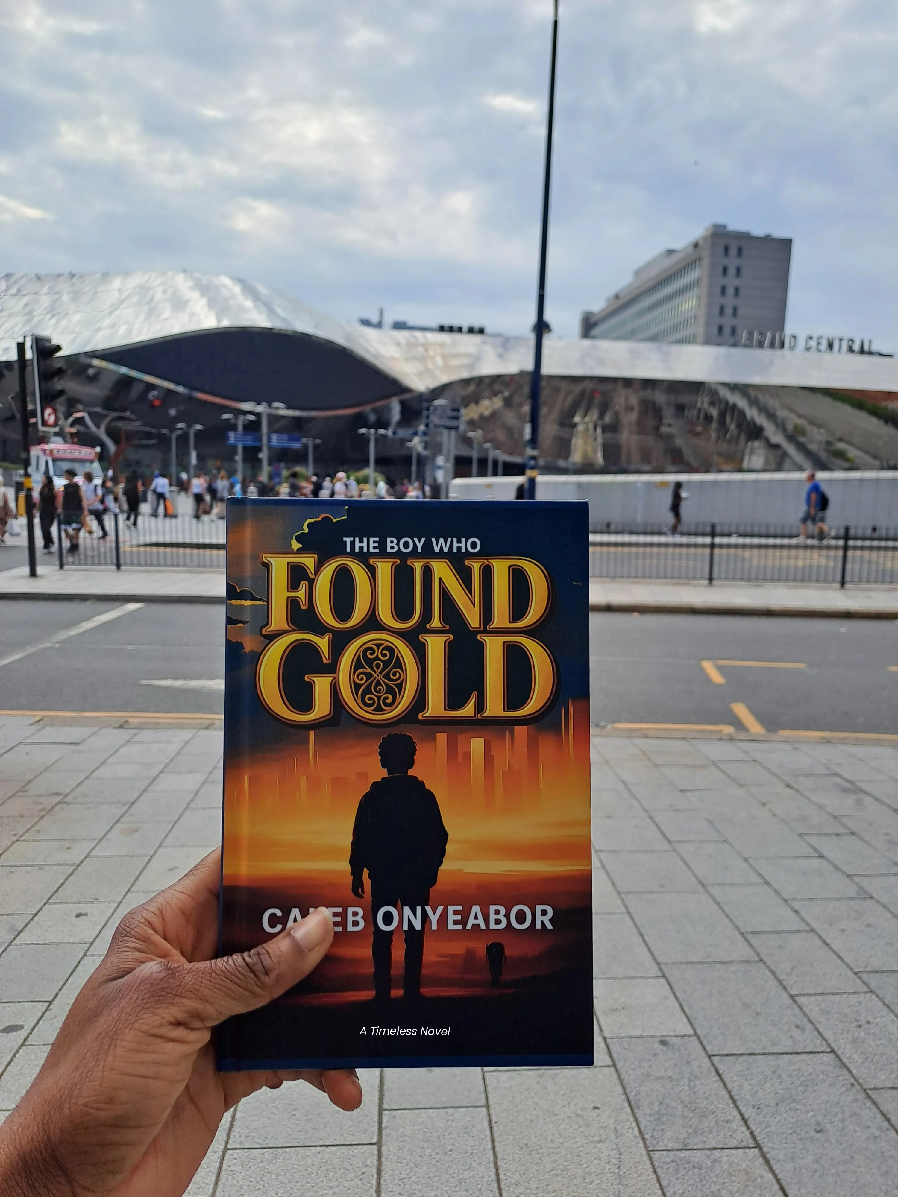 Reader holding The Boy Who Found Gold novel by Caleb Onyeabor in Accra, Ghana - African literature and inspirational fiction
