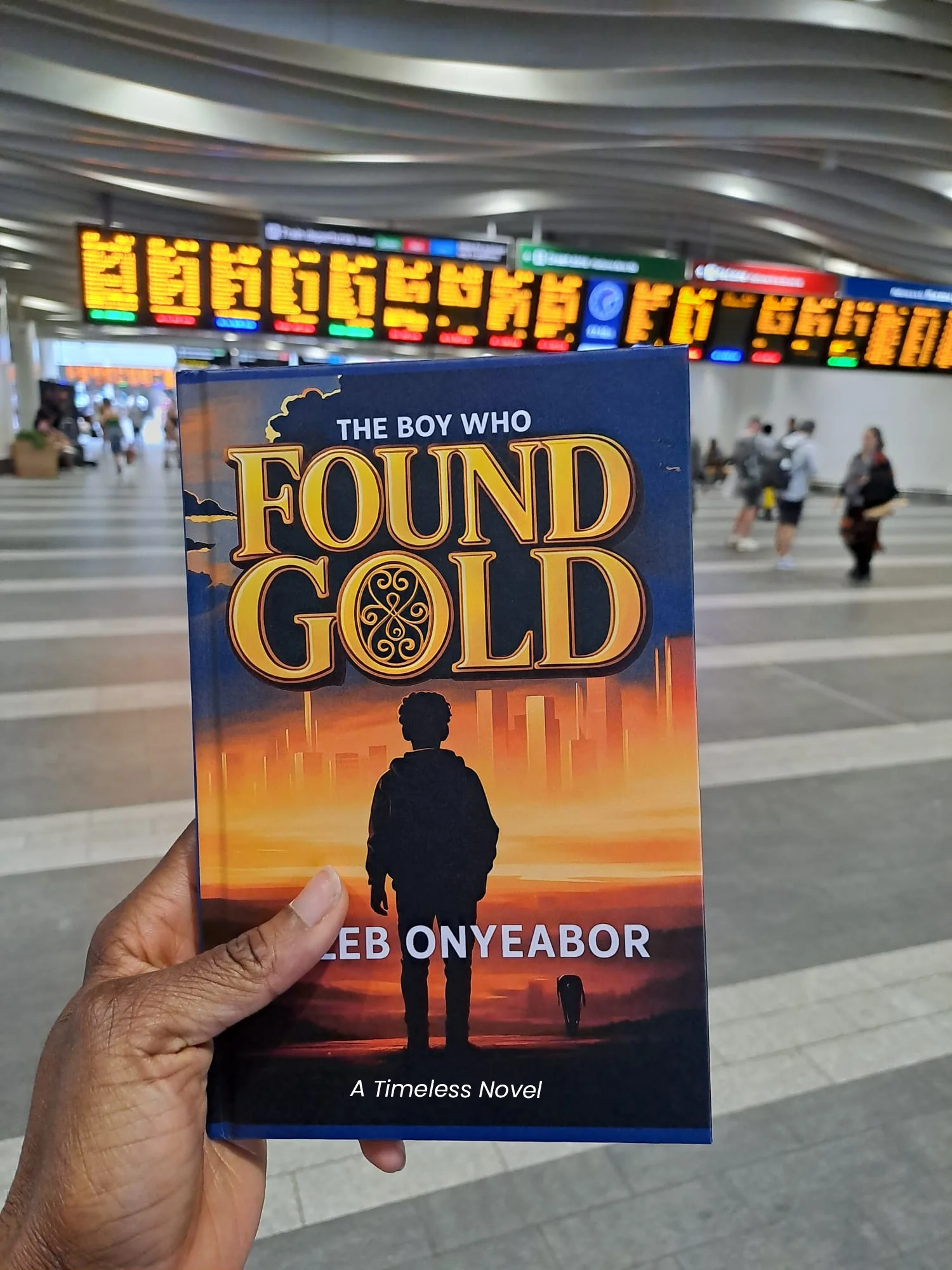 Reader enjoying The Boy Who Found Gold novel by Caleb Onyeabor in Beijing, China - inspiring story of a ghetto boy's journey